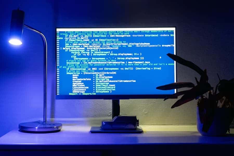 Overhead view of a coding workspace with multiple monitors
